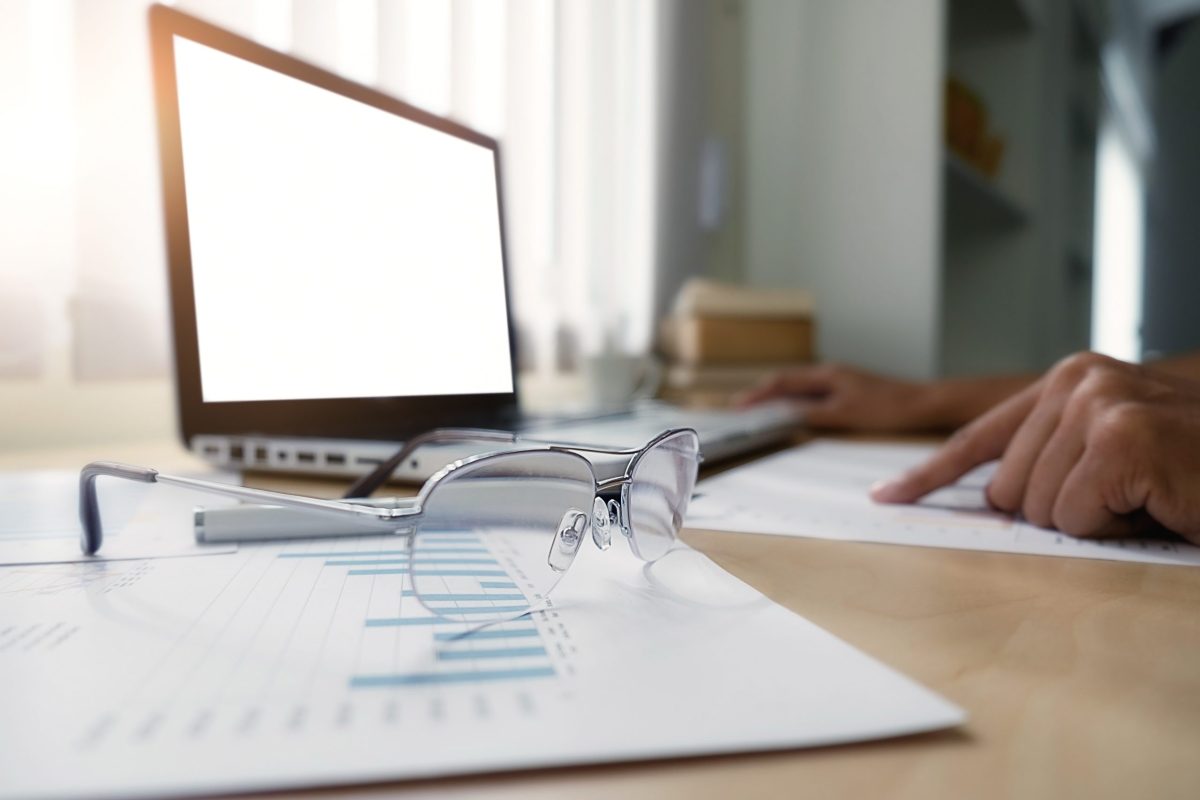 side view of Business man working at office with laptop and documents on his desk at his office while looking serious consultant ,lawyer concept,morning light,vintage color,selective focus